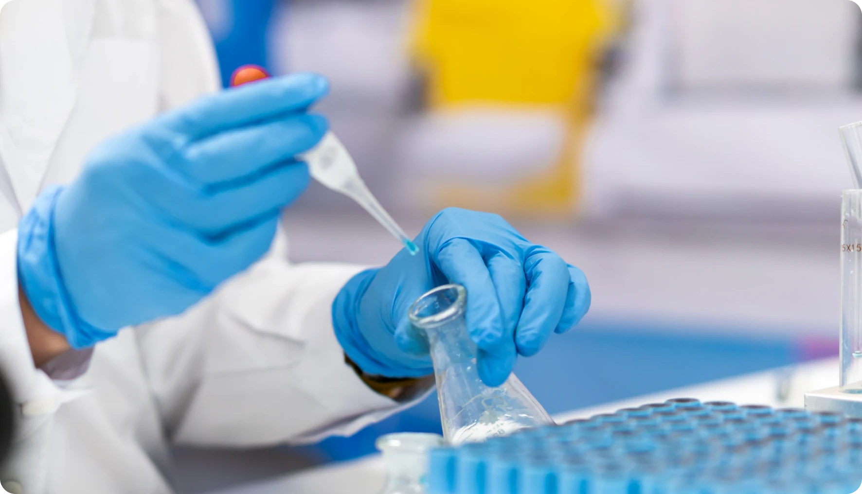 Scientist using pipette in laboratory setting.